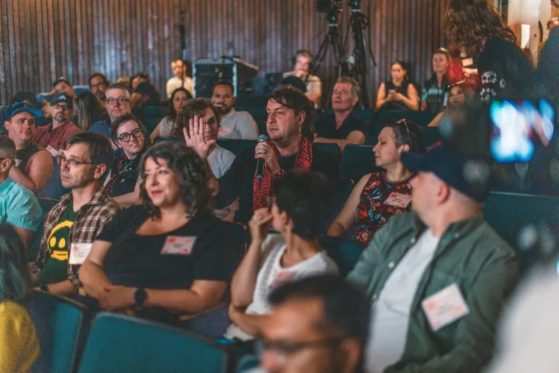 A guest raises a hand during the community runway.