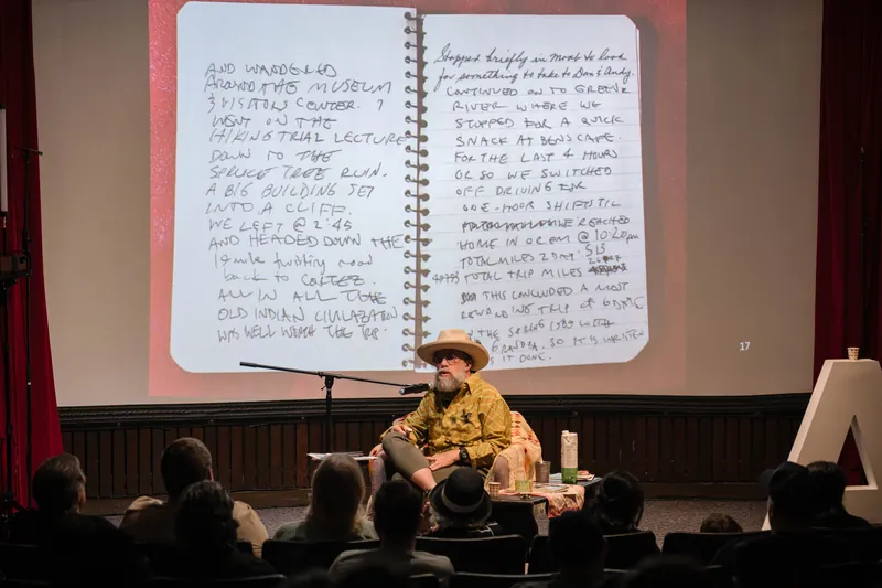 A handwritten notebook page fills Dave Olson's presentation screen.