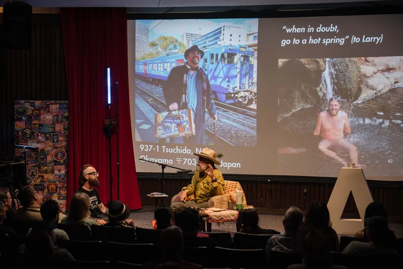 An on-stage conversation with Dave Olson — two chairs, mic, and a listening room — Tight frame.