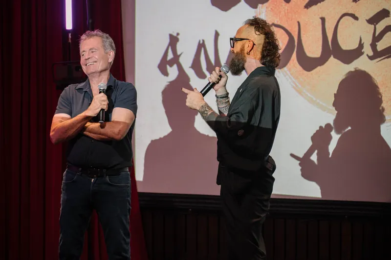 More community announcements roll on — mic handoffs and short stage spots — Closer on the mic.