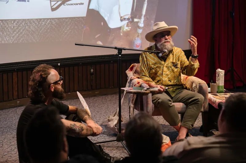 An on-stage conversation with Dave Olson — two chairs, mic, and a listening room.