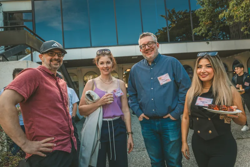 Guests share a laugh together outside before the program starts.