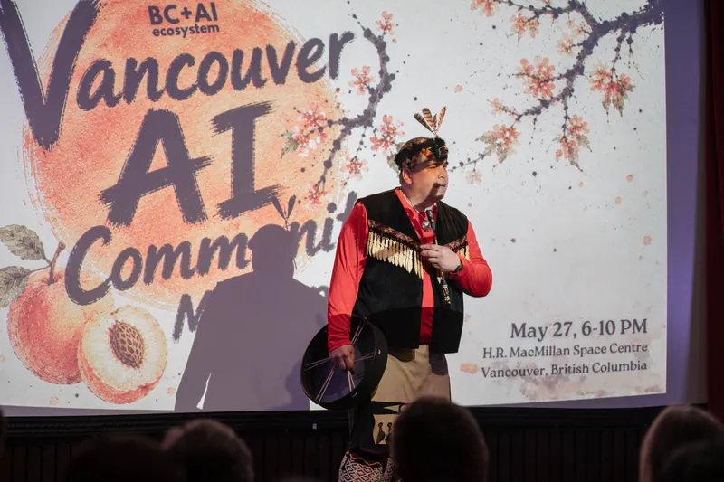 An Indigenous welcome unfolds on stage as the audience settles in — From the aisle.