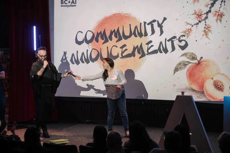 A community announcer shares updates from center stage — From the aisle.