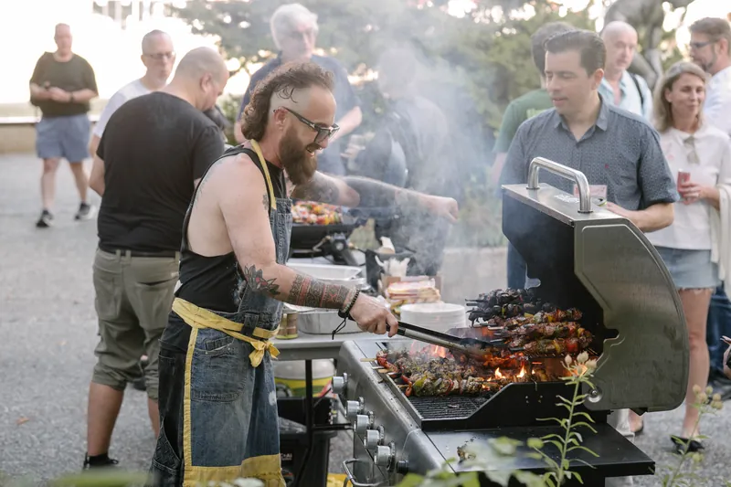 Food cooks over the outdoor grill as the pre-show BBQ gets going.