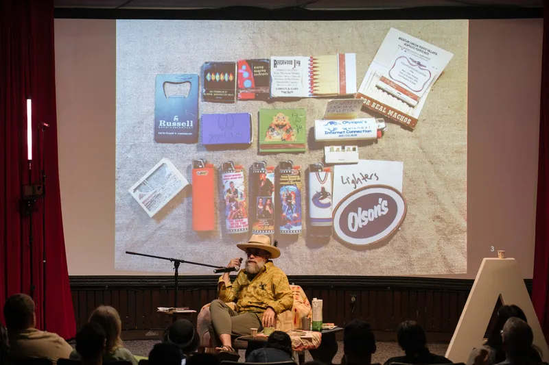 Dave Olson's talk opens with archival images and story slides behind him — From the aisle.