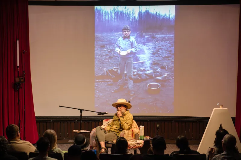 Dave Olson's talk opens with archival images and story slides behind him — Wider angle.
