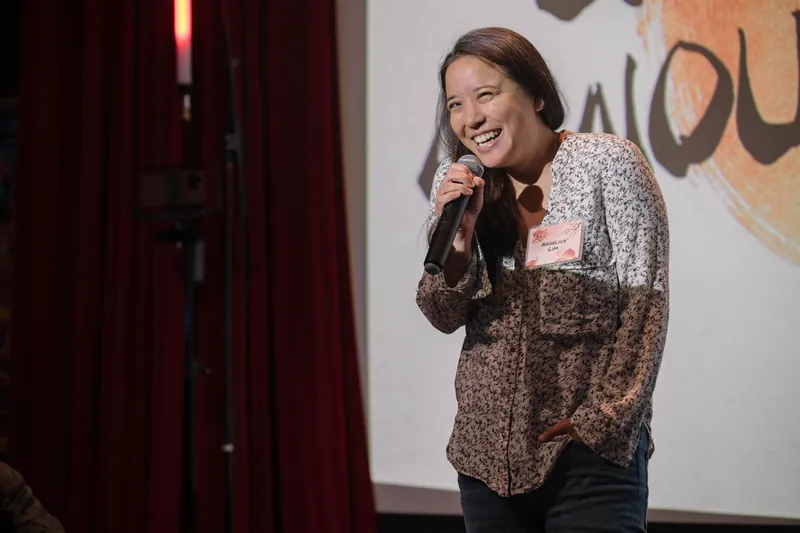 A community announcer shares updates from center stage.