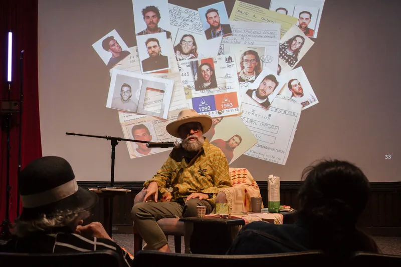 A collage of faces fills the screen behind Dave Olson.