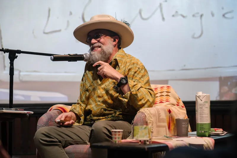 Dave Olson leans into storytelling — clippings, collages, and handwritten notes on screen — Wider angle.