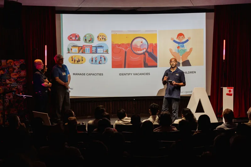 A presenter explains a capacity-management slide to the seated audience.