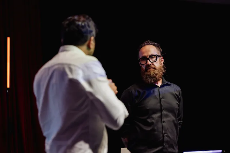 Taleeb Noormohamed faces the host as their onstage conversation begins.