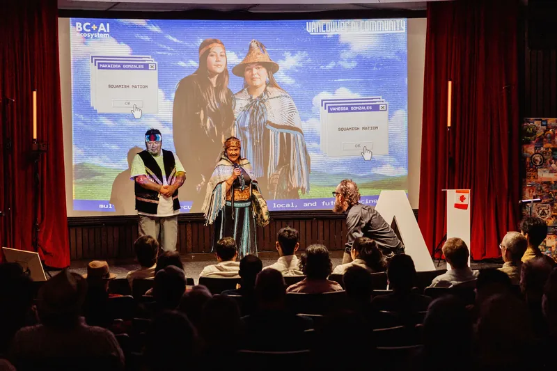 A wide auditorium view captures the cultural welcome before the seated audience.