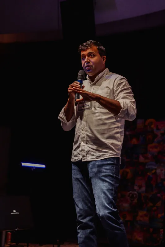 Taleeb Noormohamed speaks with his hands held close to his chest.