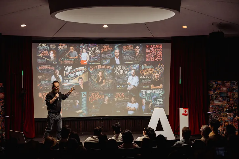 The audience watches as the host presents the Futureproof Festival lineup.