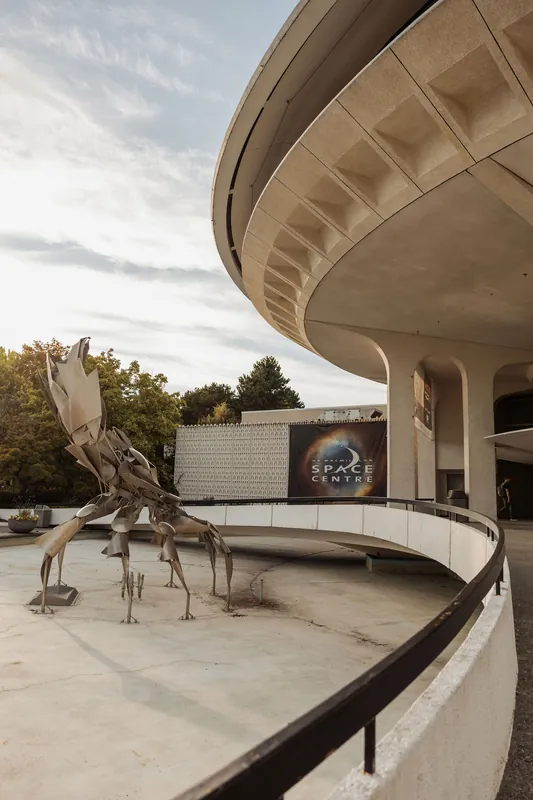 The Space Centre entrance and curved concrete canopy at dusk.