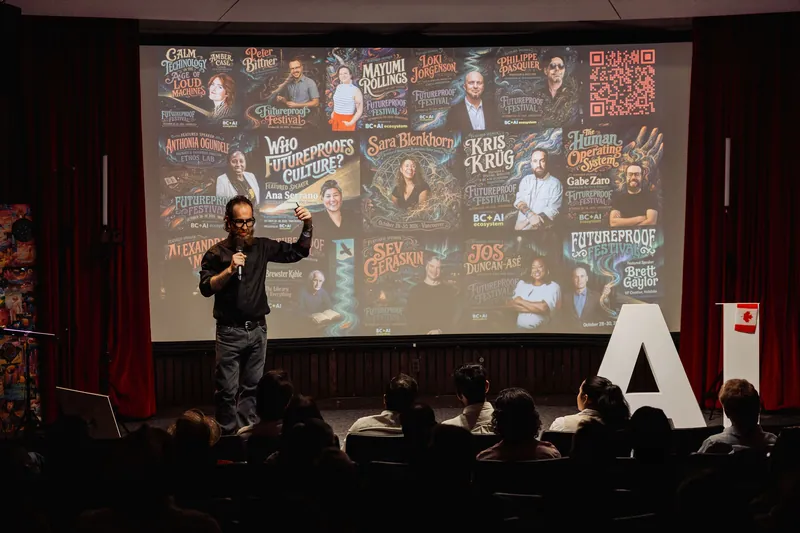 The host introduces a speaker-filled Futureproof Festival program slide.