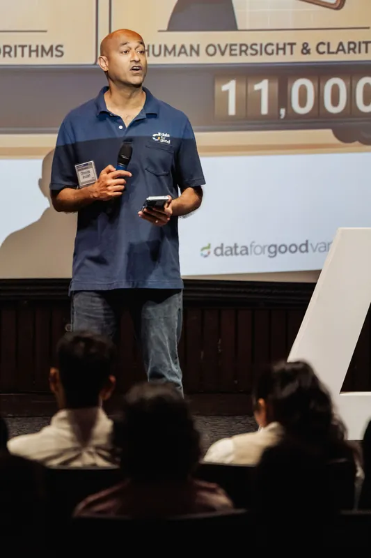 A close stage detail shows a Data for Good presenter holding a microphone and phone.