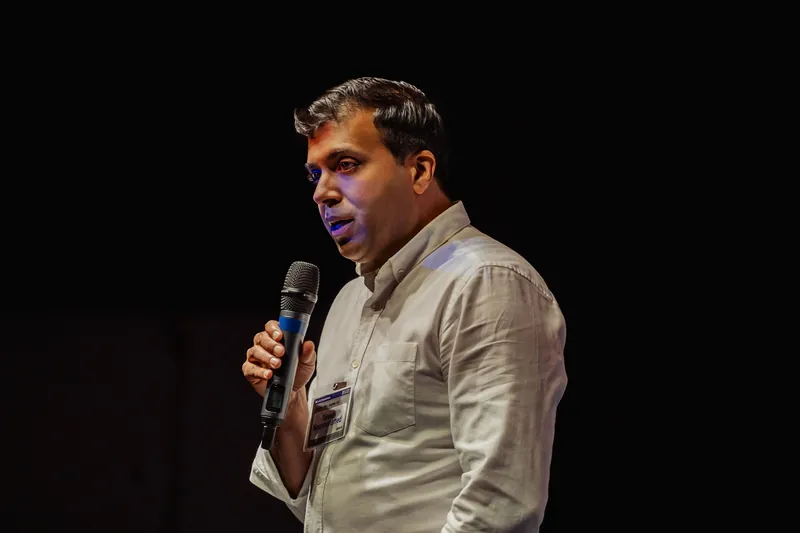 Taleeb Noormohamed speaks in a close side portrait.