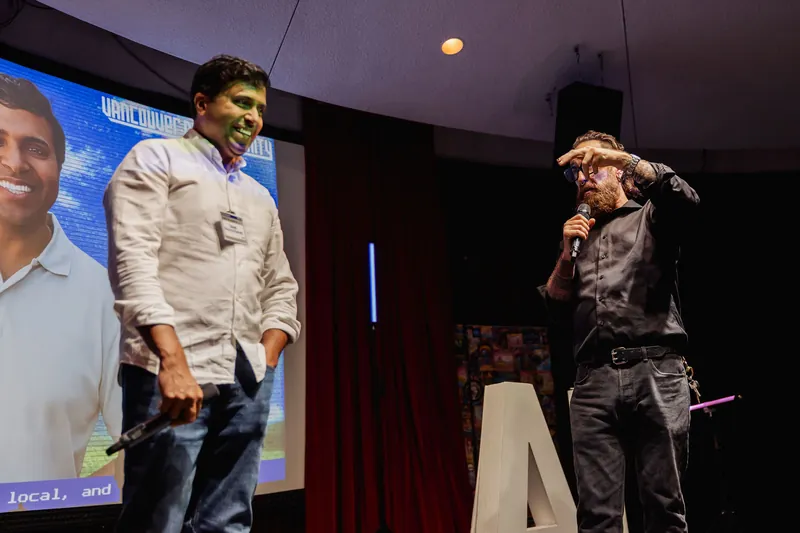 Taleeb Noormohamed smiles as the host continues the closing exchange.