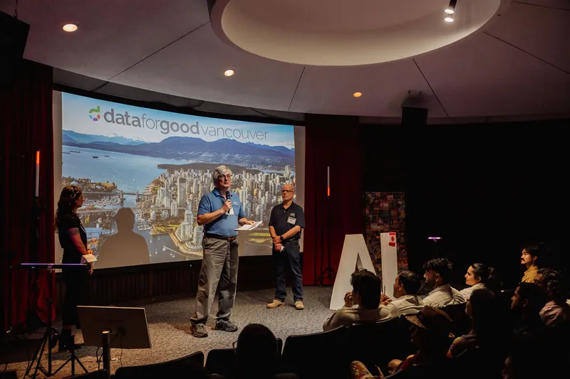 The Data for Good team presents beside a slide featuring a Vancouver map.
