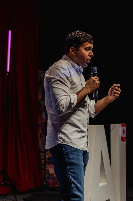 Taleeb Noormohamed speaks with the microphone close to his chest.