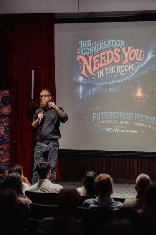 The host presents a Futureproof Festival slide to the seated audience.