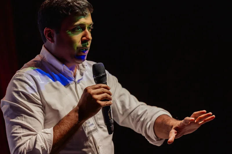 Taleeb Noormohamed extends his arm in a close, front-facing view.
