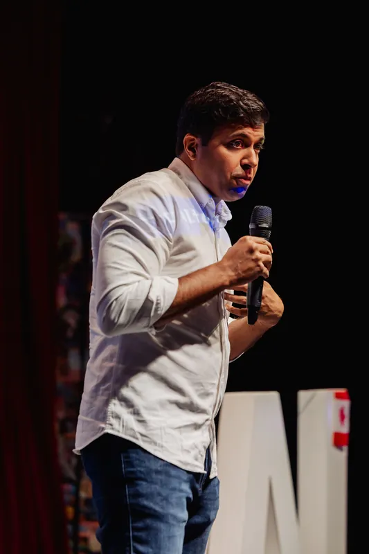 Taleeb Noormohamed emphasizes a point with a compact hand gesture.
