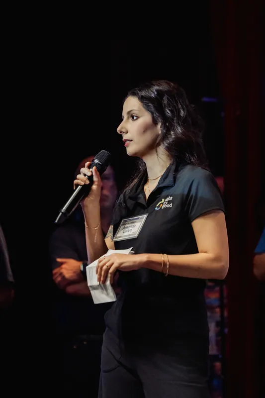 A Data for Good presenter looks toward the audience while speaking.