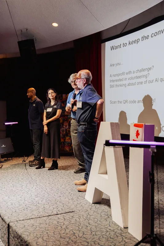 A side view shows community presenters lined up beside a follow-up QR code.
