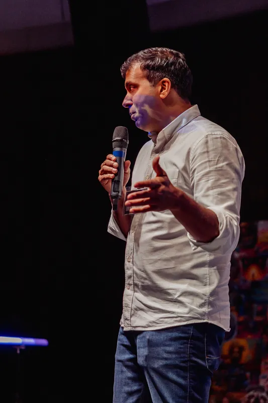 Taleeb Noormohamed continues his talk with an open hand.