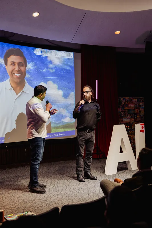 Taleeb Noormohamed and the host stand together for the closing onstage conversation.