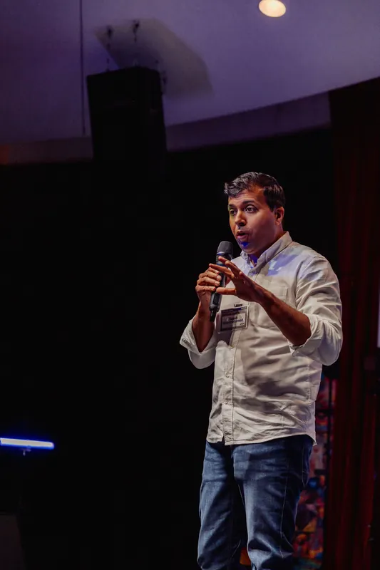 Taleeb Noormohamed makes a small hand gesture while speaking.