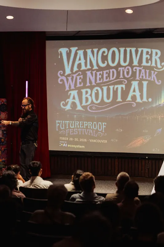The host stands before a slide reading 'We Need to Talk About AI.'