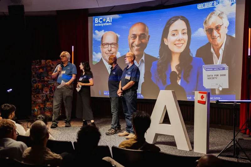 A wide view shows four Data for Good Vancouver representatives facing the audience.