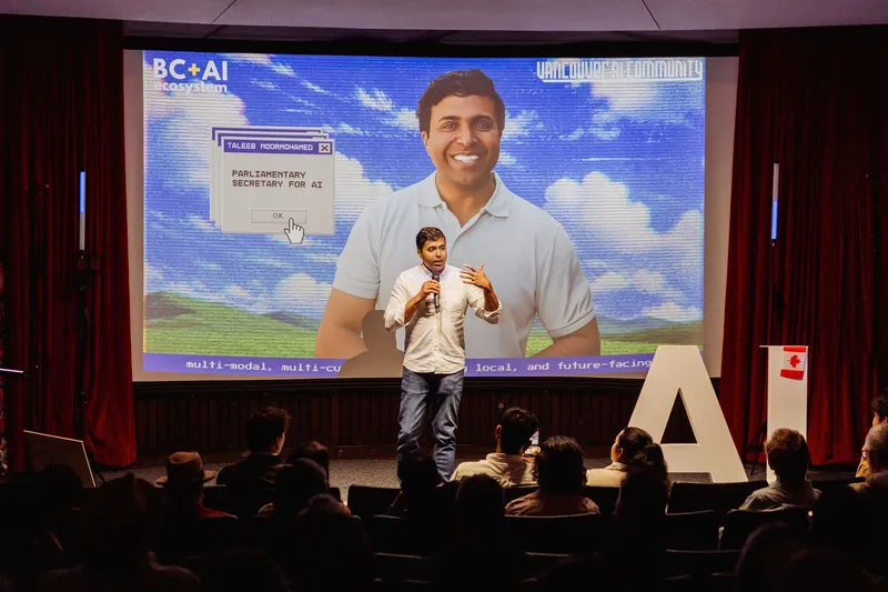 Taleeb Noormohamed addresses the full room beneath his BC + AI event slide.