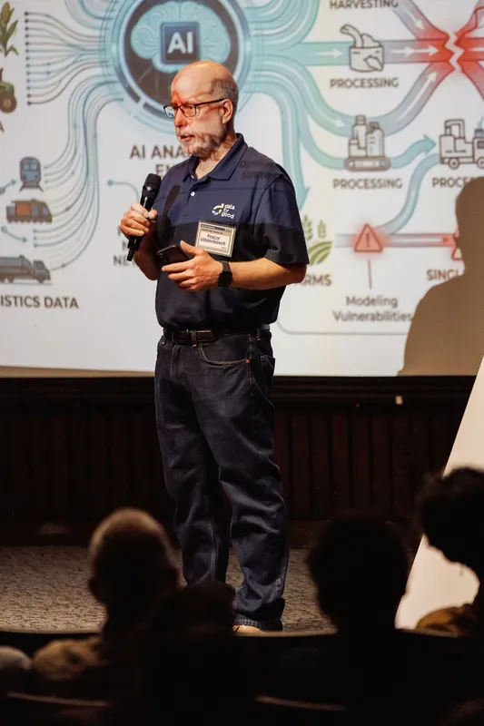A presenter speaks about AI and mental health in front of a process diagram.