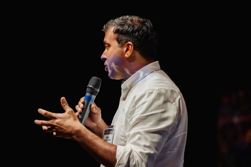 Taleeb Noormohamed emphasizes a point with both hands.
