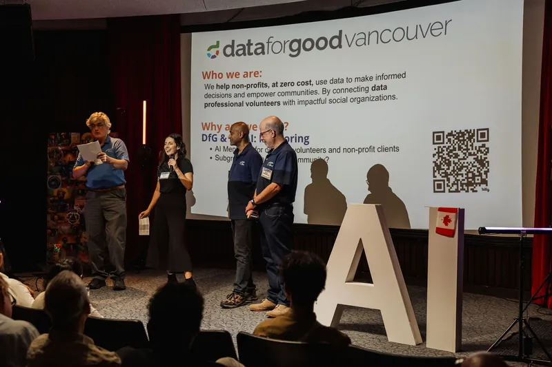 The Data for Good Vancouver team introduces its volunteer work beside an information slide.