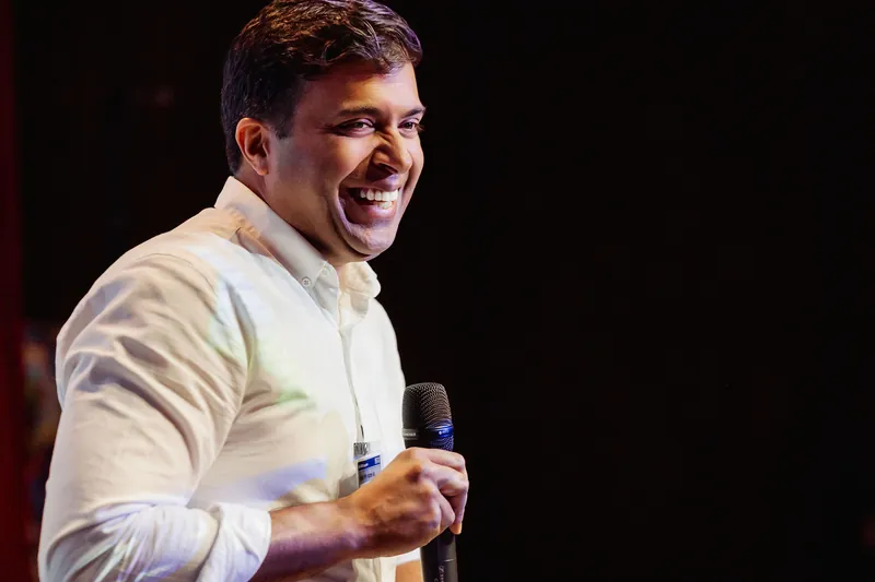 Taleeb Noormohamed smiles while beginning his talk.