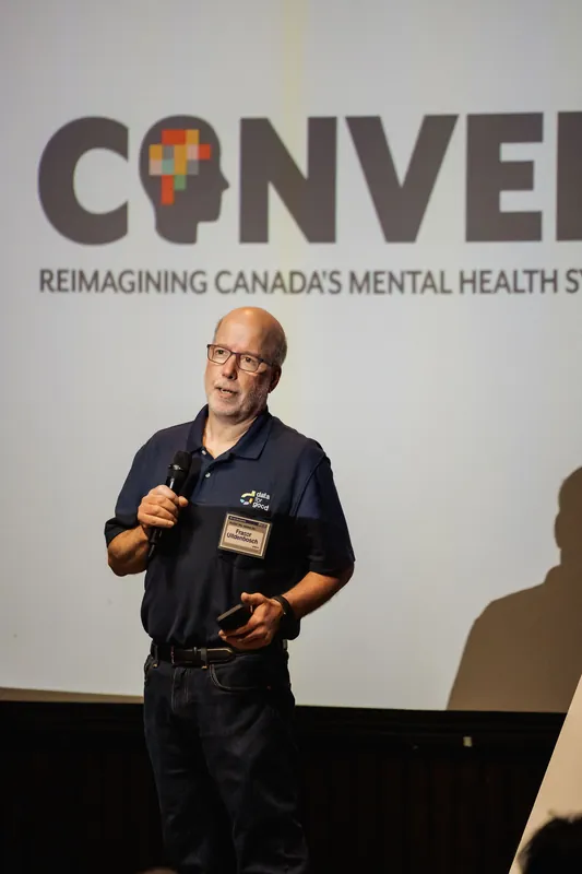 A presenter addresses the audience during the CONVERGE community presentation.