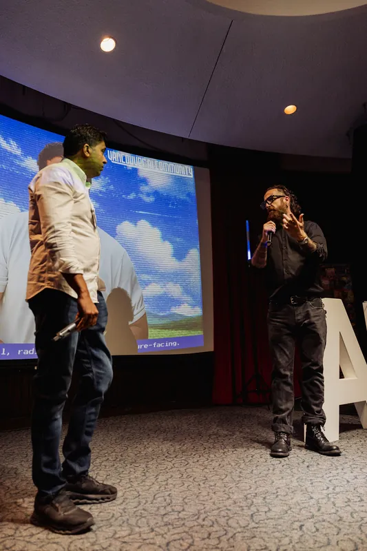 The host speaks with Taleeb Noormohamed during the closing conversation.