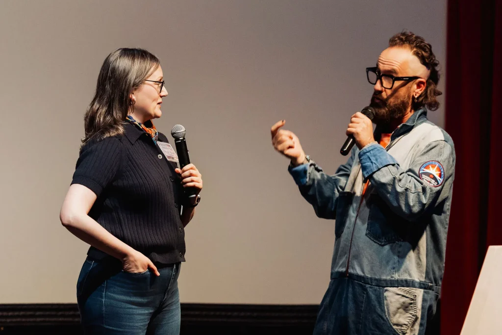Andrea Mills and Kris Krug speaking on stage at Vancouver AI in May 2026.